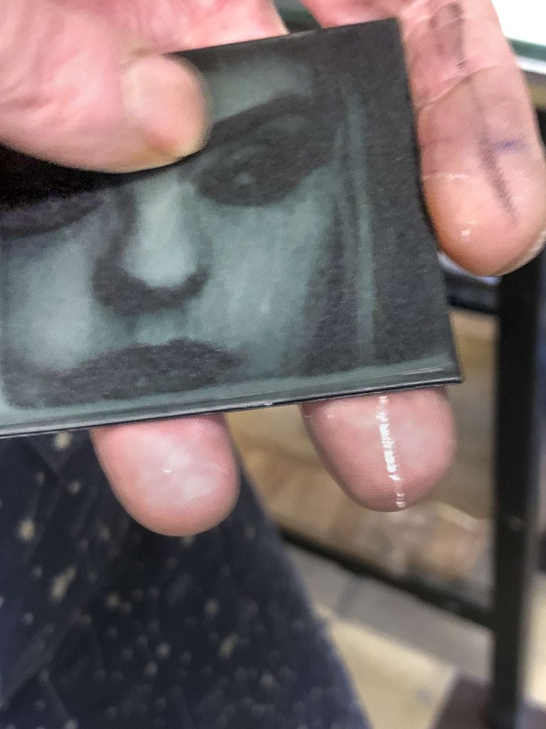 Photographe en formation. Première plaque d'essais d'un portrait sur une petite plaque photopolymère.